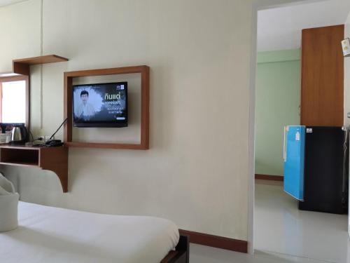 a room with a bed and a tv on a wall at ฐิติกร แกรนด์วิว in Thanya Buri