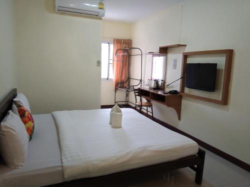 a bedroom with a bed and a mirror and a television at ฐิติกร แกรนด์วิว in Thanya Buri