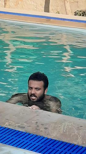 a man in the water in a swimming pool at Madho Bagh in Sawāi Mādhopur