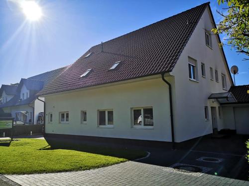 a white house with a brown roof at Pension und Ferienwohnung Walther App. 2 in Storkow