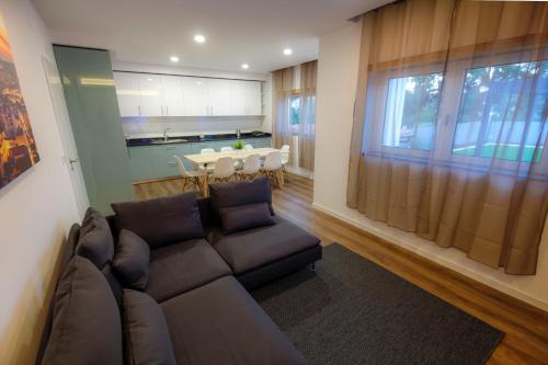 a living room with a couch and a table at Cozy Apartment With Garden in Fátima