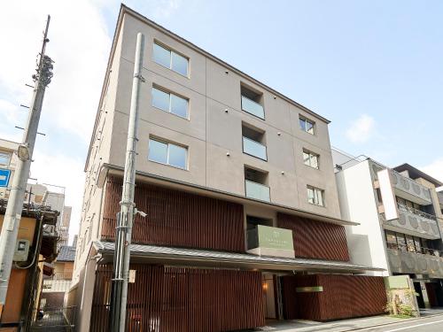 a building on the corner of a street at Tassel Inn Kyoto Kawaramachi Nijo in Kyoto