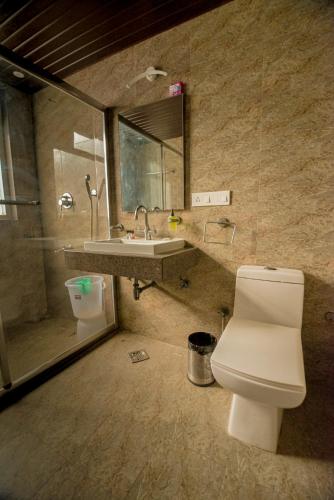 a bathroom with a toilet and a sink at Gold Nest Rubystone Heritage in Udaipur