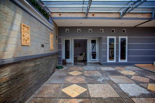 an empty lobby of a house with a glass ceiling at Villa Palm Springs by REQhome in Ciater-hilir