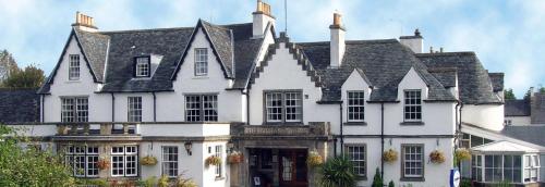 a large white house with a black roof at Buchanan Arms Hotel & Leisure, Sure Hotel Collection in Drymen