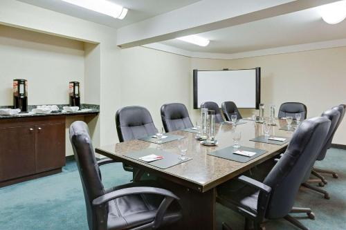 a conference room with a long table and chairs at Ramada by Wyndham Kamloops in Kamloops