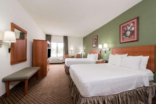 a hotel room with two beds and a television at Super 8 by Wyndham Fort Worth Downtown South in Fort Worth