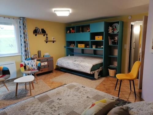 a room with a bedroom with a bed and shelves at Chambres d'Hôtes de l'Avison in Bruyères