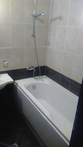 a white bath tub in a bathroom with a shower at Aspen Heights 4 beds studio in Bansko