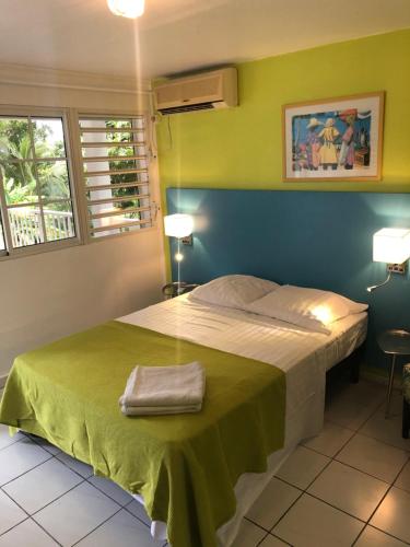 En eller flere senge i et værelse på Coco-Mango Apt B