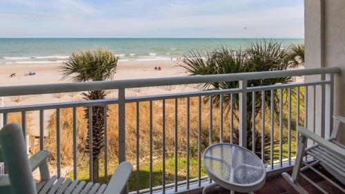 a balcony with a view of the beach at The Sandbar Hotel, Trademark Collection by Wyndham in Myrtle Beach