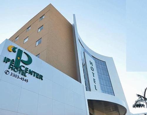 
a large building with a clock on the front of it at Ipe Center Hotel in Sao Jose do Rio Preto
