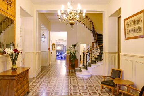 a hallway with a staircase and a chandelier at Best Western Grand Hotel de Paris & Spa in Villard-de-Lans