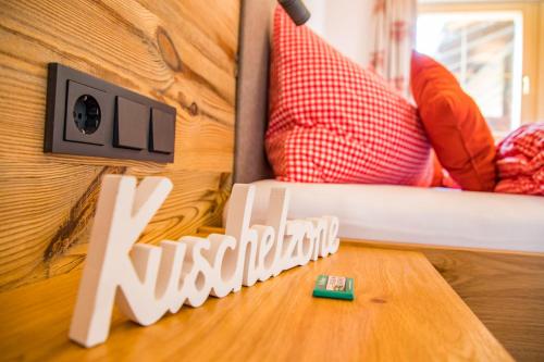 a sign that says nelson sitting on a bed at Sonnenappartements Madlstatthof in Wildschönau