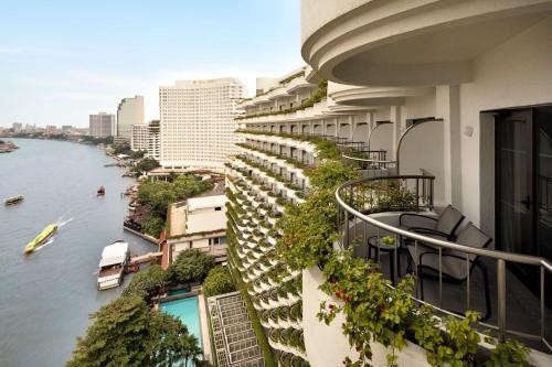 an apartment balcony with a view of a river at Shangri-La Bangkok in Bangkok