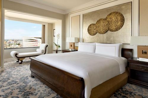 a bedroom with a large bed and a window at Shangri-La Bangkok in Bangkok