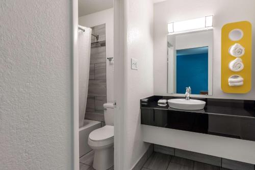 a bathroom with a sink and a toilet and a mirror at Motel 6-North Little Rock, AR - McCain in North Little Rock