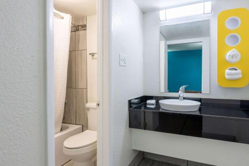 a bathroom with a sink and a toilet and a mirror at Motel 6-North Little Rock, AR - McCain in North Little Rock