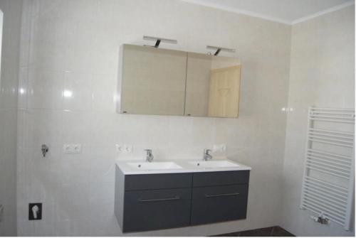 a white bathroom with a sink and a mirror at Gertis Appartment Top 2 in Stumm