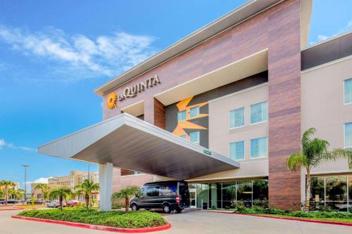 a hotel with a truck parked outside of it at La Quinta by Wyndham McAllen Convention Center in McAllen