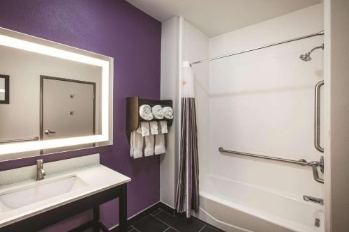 a bathroom with a white sink and a shower at La Quinta by Wyndham Lubbock South in Lubbock
