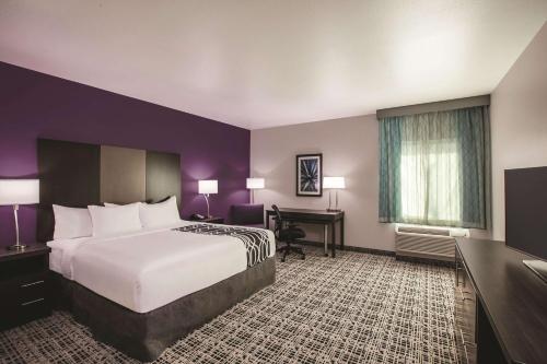 a hotel room with a bed and a desk at La Quinta by Wyndham Lubbock South in Lubbock
