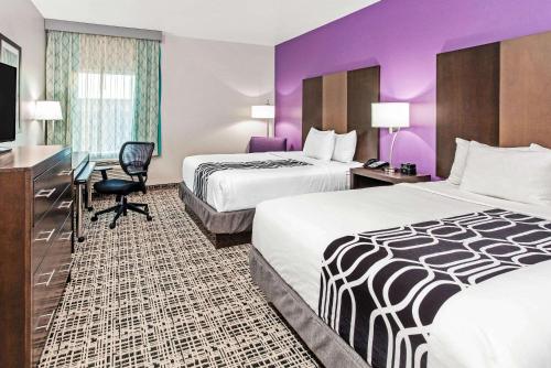 A bed or beds in a room at La Quinta by Wyndham Lubbock South