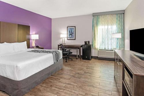 a hotel room with a bed and a desk at La Quinta by Wyndham Lubbock South in Lubbock