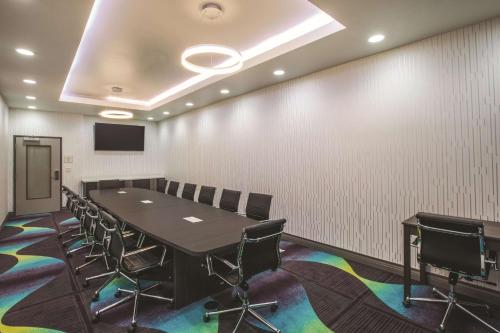 a conference room with a long table and chairs at La Quinta by Wyndham Lubbock South in Lubbock