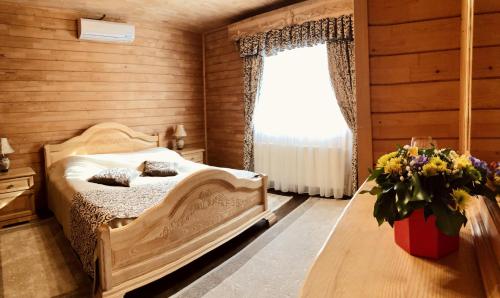 a bedroom with a bed and a window at Termal Star Complex in Nyzhne Solotvyno