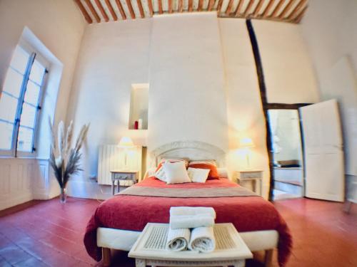 a bedroom with a large bed with towels on it at Bauhaus Saint-Pierre in Gaillac