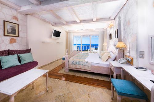a large bedroom with a bed and a couch at Kalkan Likya Residence Hotel & SPA in Kas