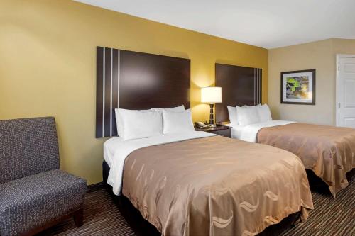 a hotel room with two beds and a chair at Quality Inn Seneca Clemson Area U S 123 in Seneca