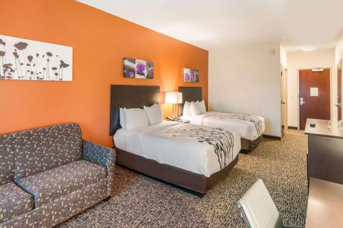 a hotel room with two beds and a couch at Sleep Inn & Suites Hurricane Zion Park Area in Hurricane