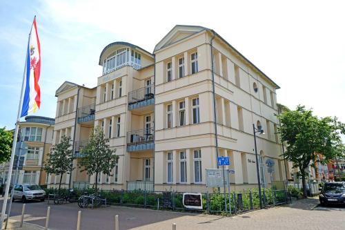 un bâtiment doté d'un drapeau devant lui dans l'établissement Villa Anna Meerblick erste Reihe, à Ahlbeck