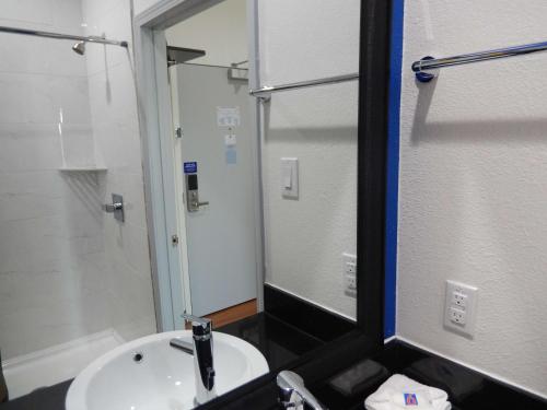 a bathroom with a sink and a mirror at Knights Inn Houston in Houston