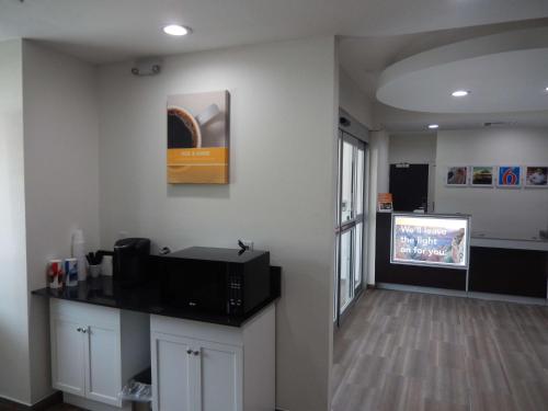 a room with a living room with a tv and a living room at Knights Inn Houston in Houston