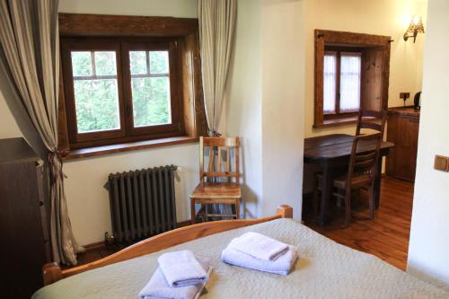 a bedroom with a bed with two towels on it at Gungas in Ādaži