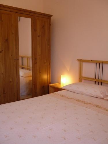 a bedroom with a bed and a lamp on a table at Agriturismo Tenuta La Siesta in Gallipoli
