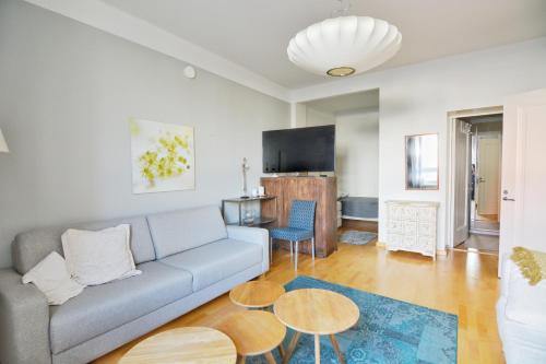 a living room with a couch and a table at HOMELY - City Apartment 50m2 in Helsinki