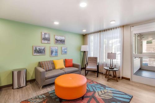 a living room with a couch and a table at WoodSpring Suites Bakersfield Airport in Bakersfield