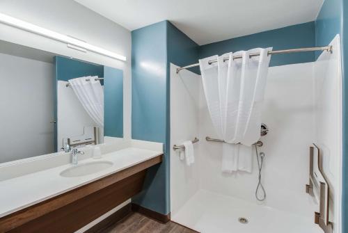 a bathroom with a sink and a shower at WoodSpring Suites Bakersfield Airport in Bakersfield