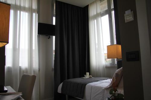 a hotel room with a bed and a window at Hotel Zara Milano in Milan