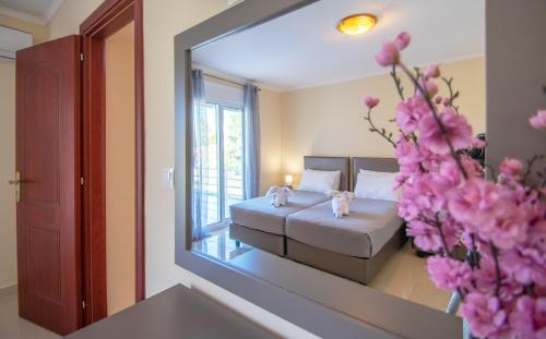 a view of a bedroom with a bed and a mirror at Zante Sun II - Getaway Villa! in Kalpaki