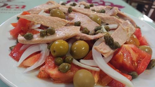 a plate of food with meat and vegetables on it at La Pata de Oca Hostal Rural y Albergue in Torres del Río