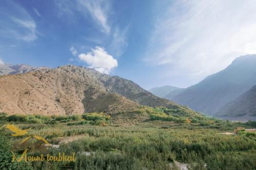 a view of a mountain range with mountains in the background at Mount Toubkal Lodge in Imlil