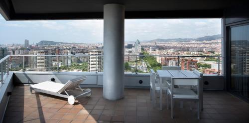 a balcony with a table and chairs and a view of a city at Barcelona Princess in Barcelona