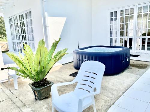a white chair and a blue tub on a patio at Bandarawela luxurious villa in Bandarawela