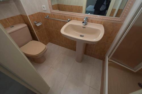 a bathroom with a sink and a toilet and a mirror at Topacio i 211a in Calpe