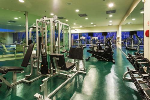 a gym with treadmills and chairs in a room at Crowne Plaza Torreon by IHG in Torreón